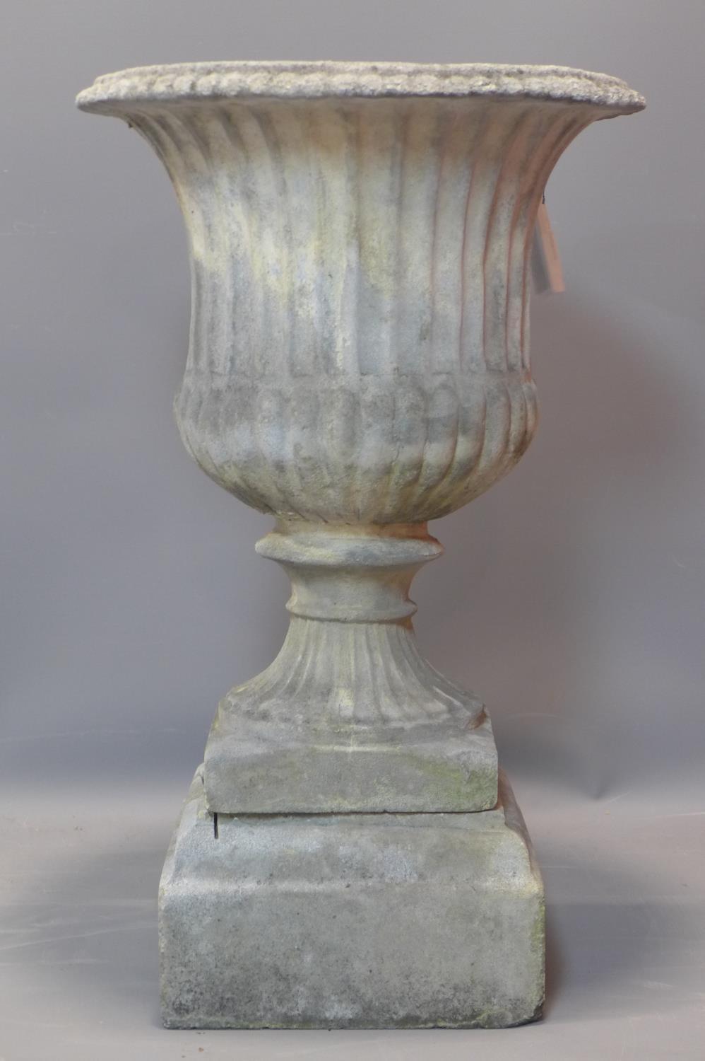 A reconstituted campana style garden urn, on stepped pedestal base, H.75cm Diameter 42cm