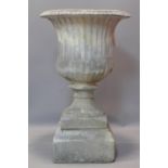 A reconstituted campana style garden urn, on stepped pedestal base, H.75cm Diameter 42cm