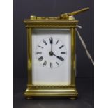 A 20th century French gilt brass carriage clock, the enamel dial with Roman numerals, having key,