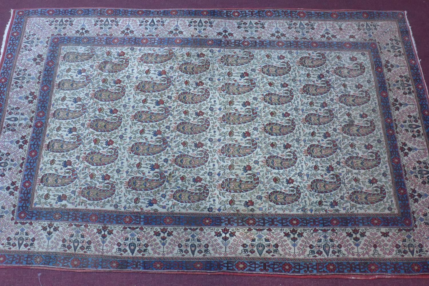 A Persian Qum rug, with all over Boteh motifs on a cream ground, within stylised floral borders, 216