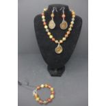 A Picasso jasper suite, comprising beaded necklace with Jurassic ammonite pendent, beaded bracelet