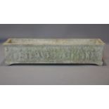 A reconstituted stone rectangular planter, the frieze decorated in relief with a continuous