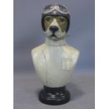 A moulded bust of a dog dressed as a racing driver, raised on socle base, H.52cm