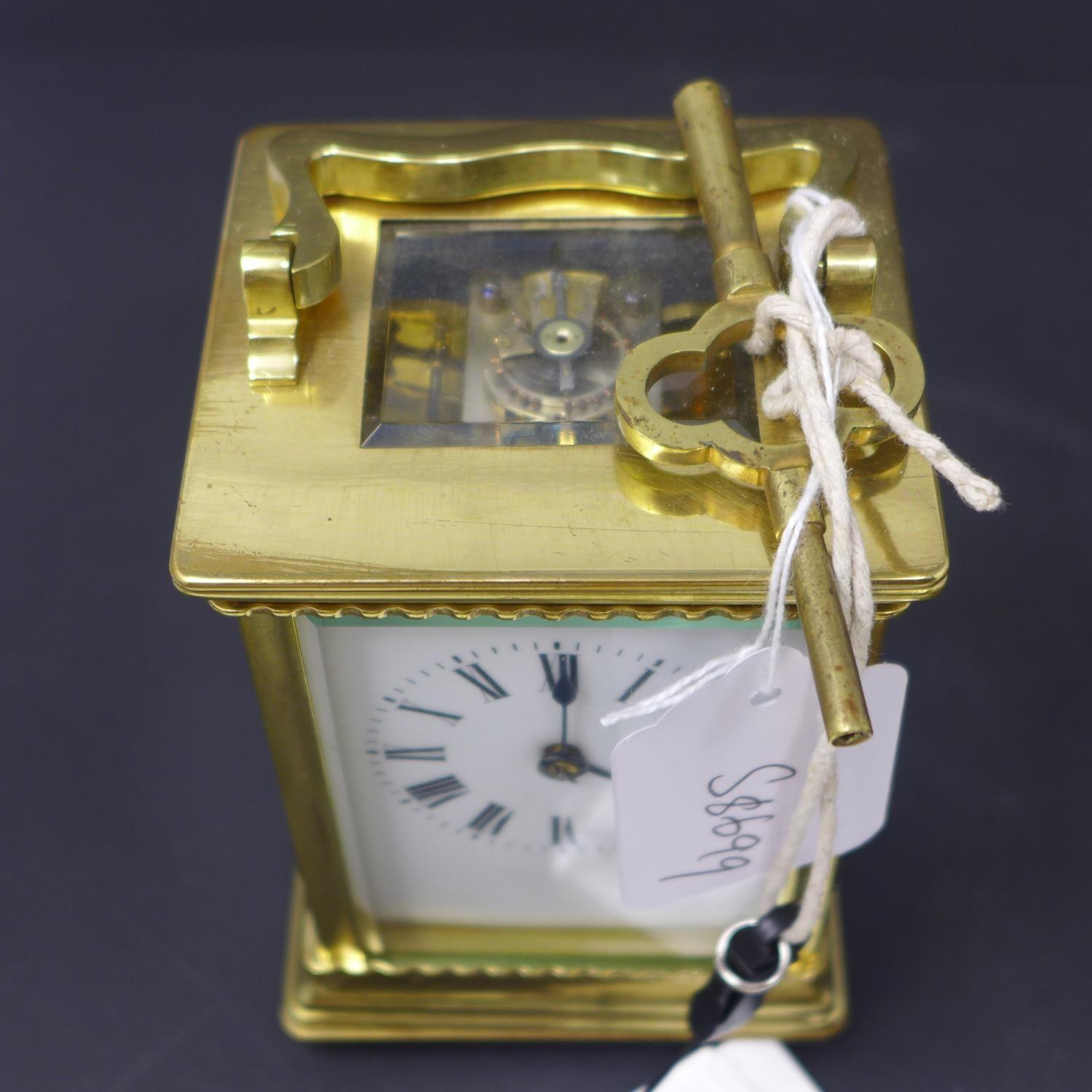 A 20th century French gilt brass carriage clock, the enamel dial with Roman numerals, having key, - Image 5 of 5