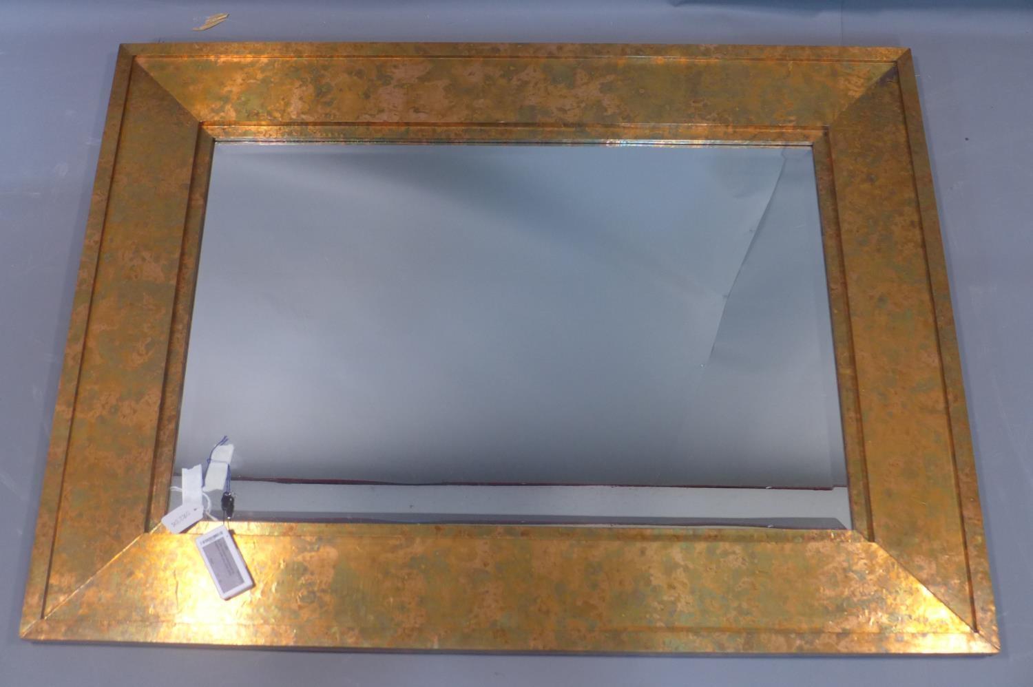 A contemporary copper clad mirror, with rectangular bevelled plate, 121 x 91cm