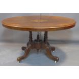 A Victorian inlaid mahogany oval tilt top dining table, with floral marquetry inlay to top, above