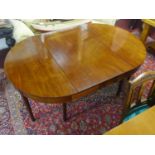 A mahogany D-end dining table, with extra leaf, raised on tapered legs, H.73 W.127cm, leaf depth