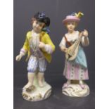 A pair of West German porcelain figurines by Martha Budich of a woman playing the lute and a man