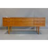 A Danish teak sideboard by Steens, with two central long drawers flanked by four short drawers, on
