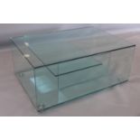 A contemporary glass coffee table, with tier to interior, H.35 W.80 D.57cm
