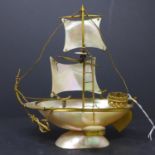 A French mother of pearl shell inkwell modelled as a sailing ship, with gilt metal rigging,