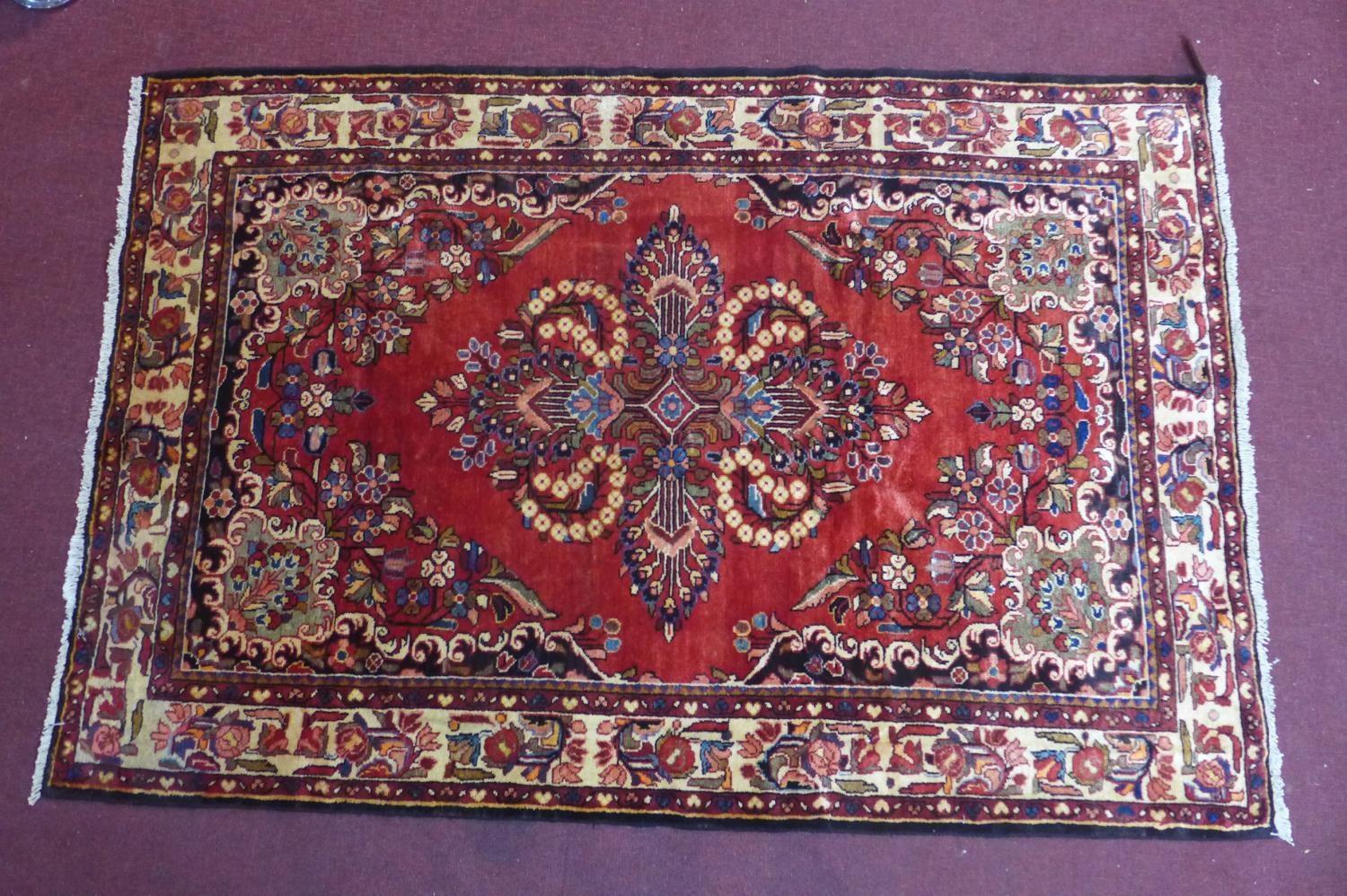 A South-West Persian Lilihan rug, central double pendent medallion with repeating petal motifs on