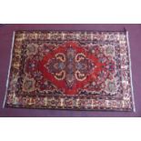 A South-West Persian Lilihan rug, central double pendent medallion with repeating petal motifs on