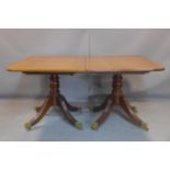 A Regency mahogany extending dining table, with two extra leaves, on turned supports on quadri-
