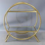 A Maison Jansen style gilt two tier shelf, with bevelled mirrored tops, having a circular frame,