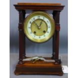 A 20th century mantel clock, with four reeded columns, on stepped rectagangular base, the white