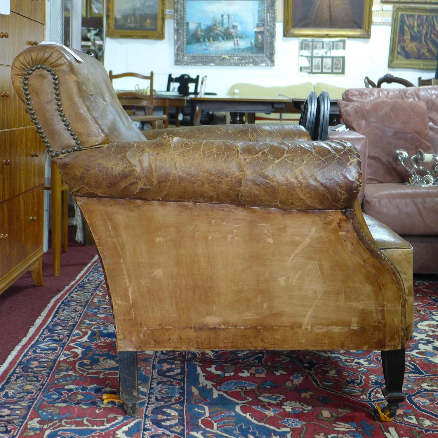 A 20th century stud bound brown leather club armchair, H.83 W.84cm, heavily worn, with cracks to - Image 2 of 3