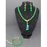 A Chinese jade beaded necklace with jade pendent, together with matching beaded jade earrings and