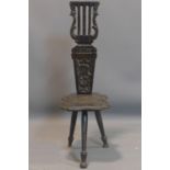 A Victorian oak harp back spinning chair, with carved rosette motif, H.87cm