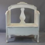 A vintage distressed painted pine settle, possibly French, with carvings to arms, on cabriole