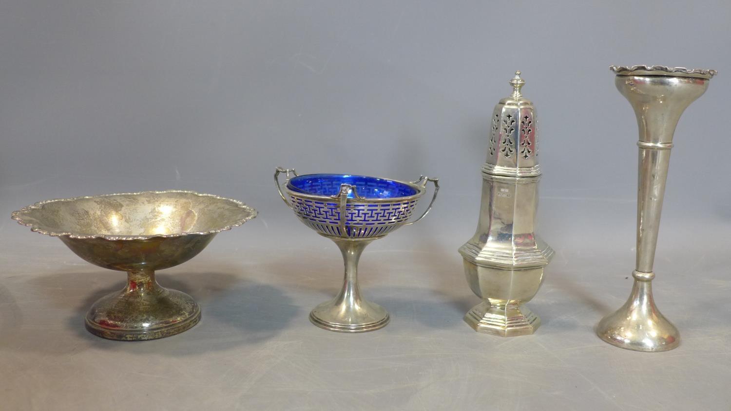 A collection of silver items, to include a sugar caster, a fruit basket, a flower pot ans a cup with