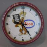 A vintage Esso wall clock, with tiger holding sign 'Put a Tiger in your Tank', the dial with