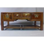 A Chinese elm coffee table, with four drawers, on square legs with under tier rack, H.50 W.115 D.