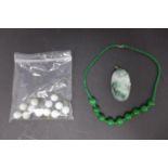 A beaded jade necklace and bangle (needs restringing) and a carved jade pendant