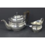 A silver teapot, with Bakelite handle and finial, Sheffield 1904, together with a silver milk jug,