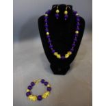 A beaded purple jade and gold plated jewellery suite, to include necklace, bracelet and earrings