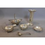 A collection of silver items, to include two creamers, one flower vase, one saucers with spoon,