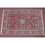 An antique Persian Kashan rug, central floral medallion with floral motifs on a maroon ground,