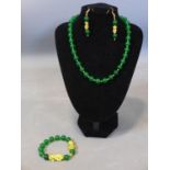 A Chinese beaded jade and gold plated necklace, bracelet and earrings