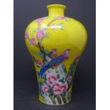A 20th century Chinese famille rose vase, decorated with birds and blossoming flowers on a yellow