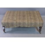 A late 19th / early 20th century leopard print upholstered hearth stool, on turned legs and castors,