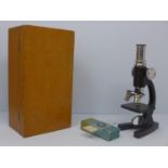 A cased miniature microscope with two glass slides, boxed, H.19cm