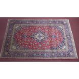 A Central Persian Kashan carpet, central double pendant medallion with repeating petal motifs on a