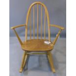 An Ercol beech and elm rocking chair, marked BS 1960 to base, H.84cm