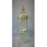 A contemporary gilt metal storm lantern, on stand with three scrolling feet, H.109cm
