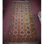 An Afghan Bokhara rug, elephant pad motifs on a red/brown ground, within geometric borders, 220 x