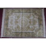 An Aubusson style rug, central medallion and stylised floral motifs on a cream ground, within