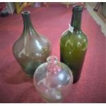 Three vintage glass bottles of varying size and shape, H.40cm (largest)