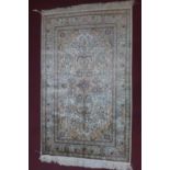 An antique Turkish Hereke silk rug of French design, with central floral medallion and stylised