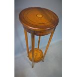 An Edwardian Sheraton Revival inlaid mahogany jardiniere stand, with two circular tiers with fan