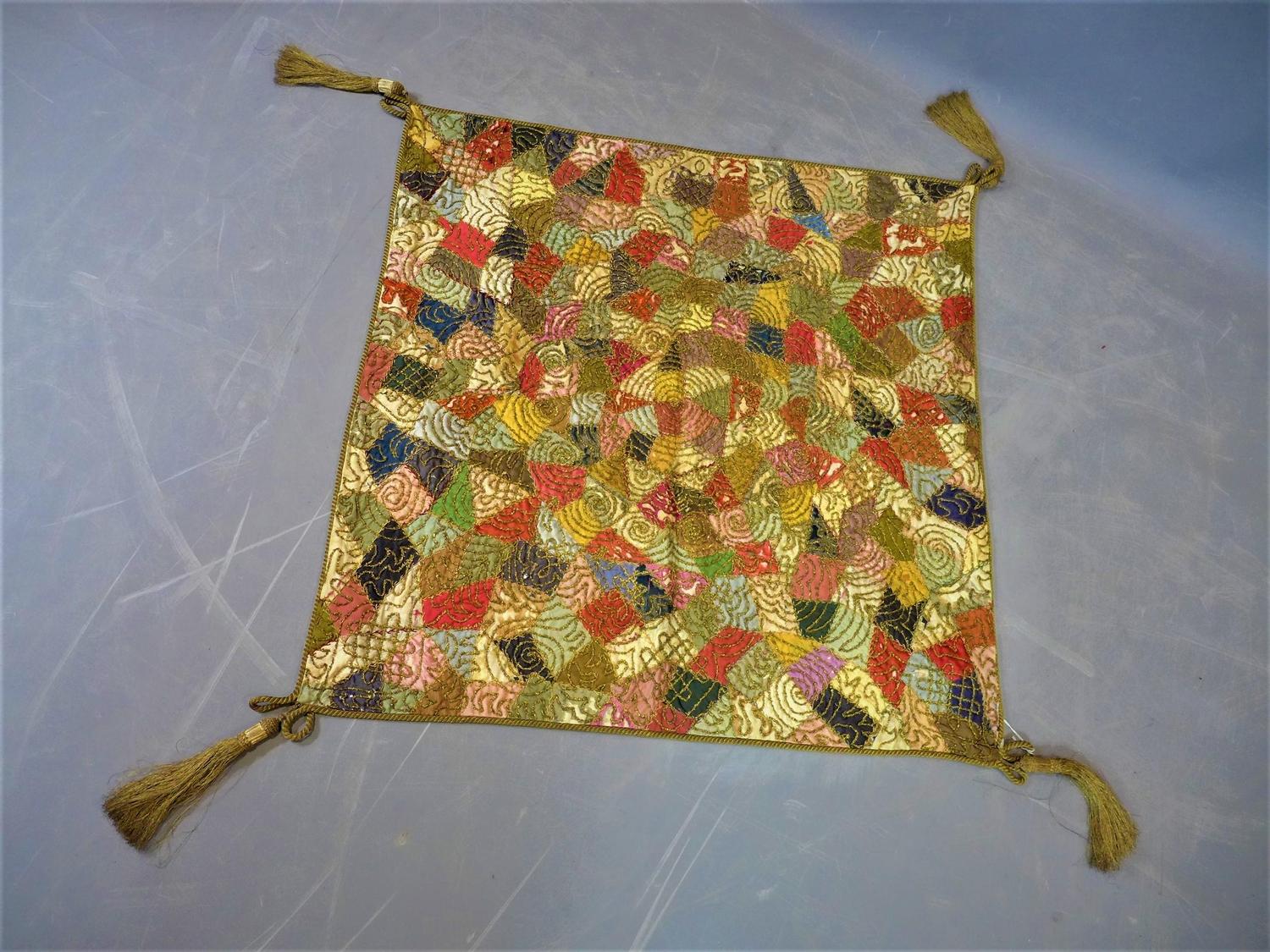 A small Middle Eastern part silk patchwork embroidery, with gilt scrolling decoration and gilt