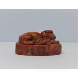 A Chinese soapstone seal, carved with a guardian dog, H.3.6 W.7 D.4cm