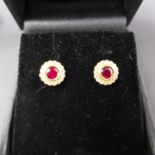 A pair of 18ct yellow gold, ruby and diamond cluster earrings, 0.60cts total
