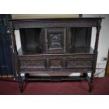 A 19th century stained oak sideboard, with central cupboard door above two short drawers, raised