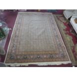 A cream ground Oriental carpet, all over petal motifs and geometric motifs on a cream field,