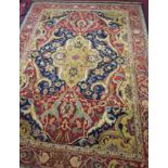 A fine Agra carpet, with central floral medallion and scrolling foliage on a navy blue ground,